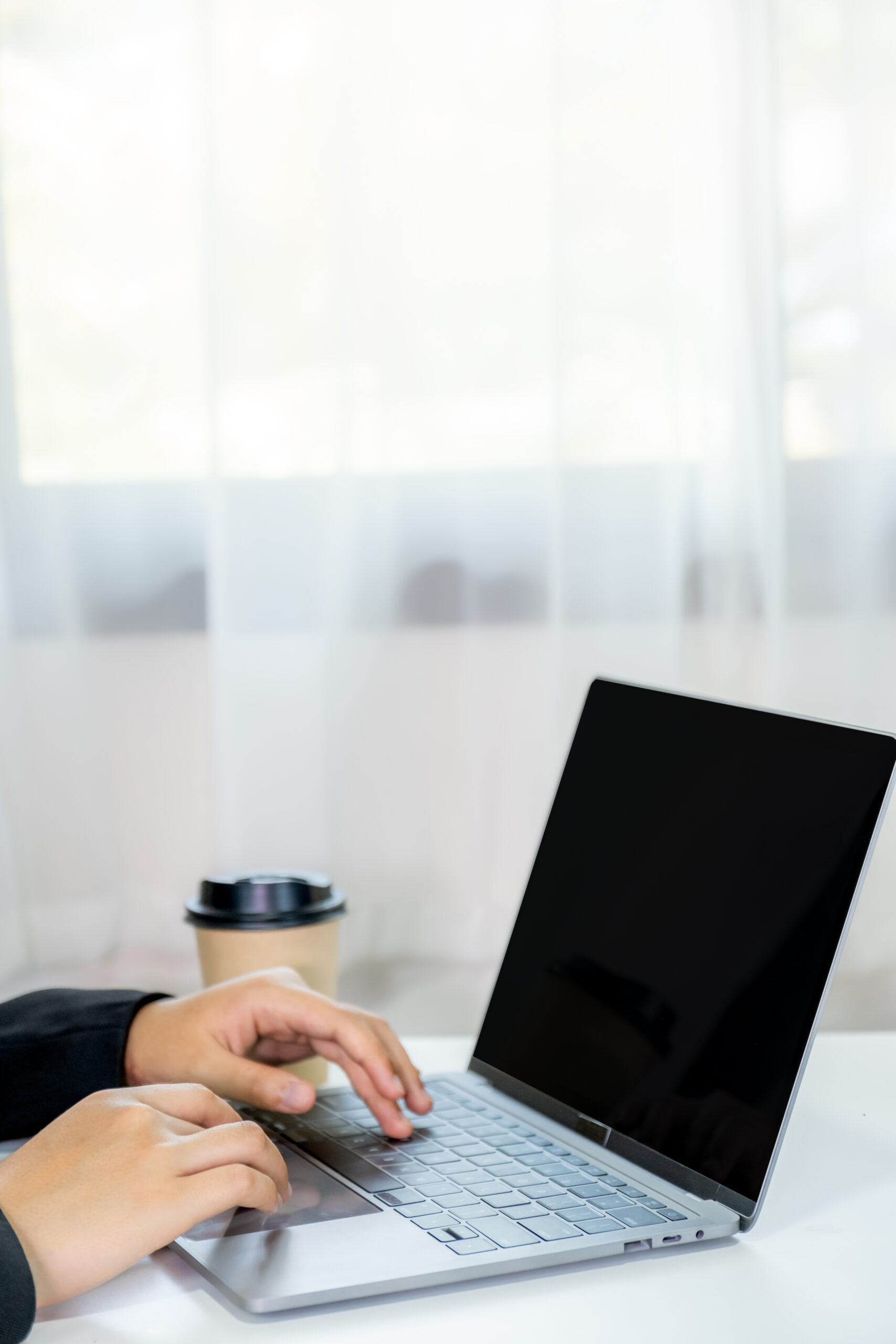 Designer’s hands coding a photography portfolio website on laptop