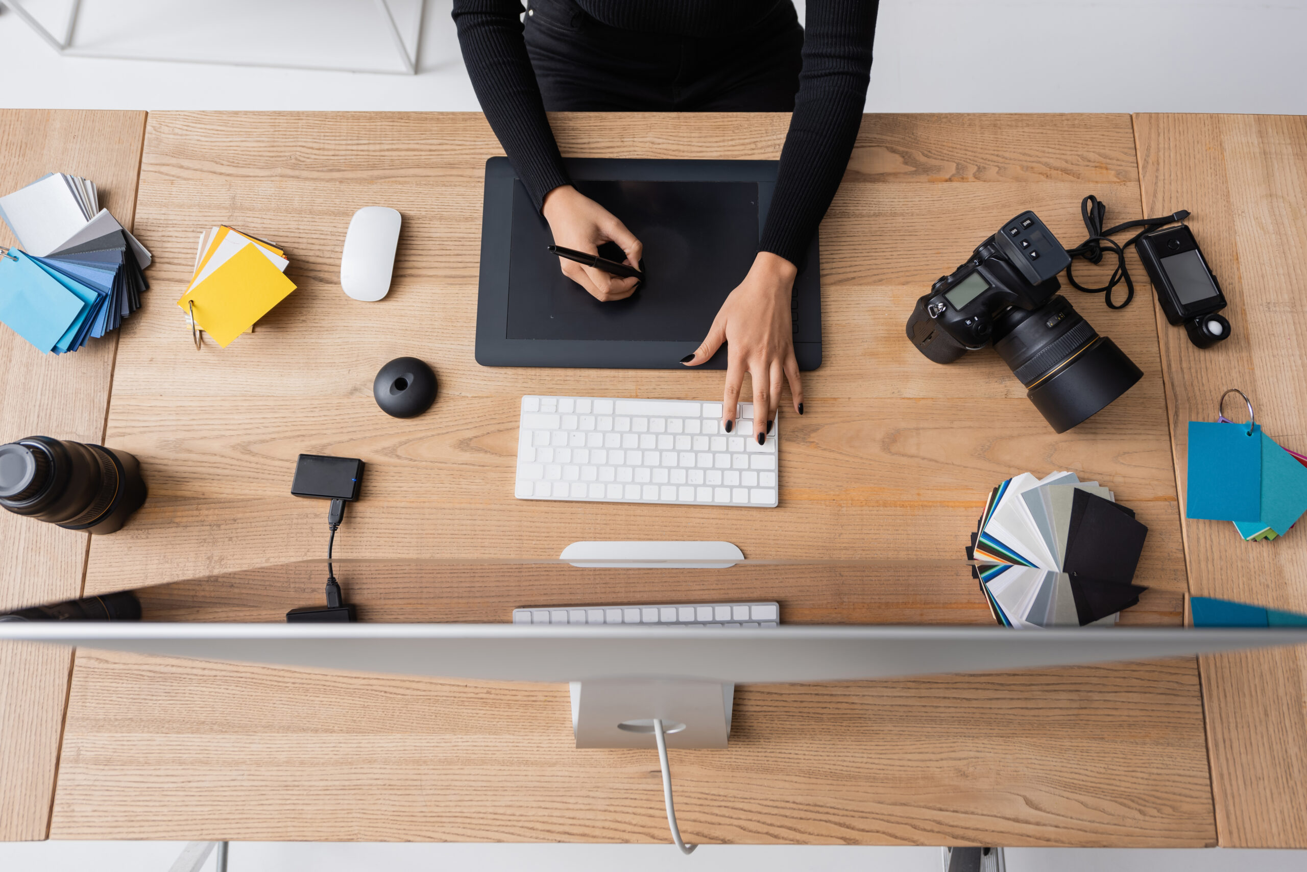 A photographer edits her site with her camera resting nearby — blending the technical with the artistic in a cozy workspace.